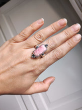 Load image into Gallery viewer, A woman&#39;s hand holding a Kathrin Jona Rhodochrosite Statement Ring.
