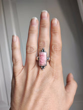 Load image into Gallery viewer, A woman&#39;s hand holding a Kathrin Jona Rhodochrosite Statement Ring.
