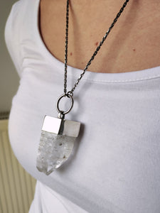 A woman wearing a Twin Point Quartz Statement Necklace by Kathrin Jona.