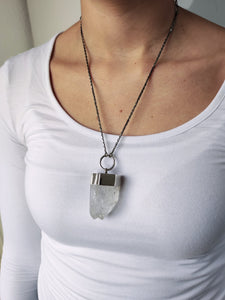 A woman wearing a Twin Point Quartz Statement Necklace by Kathrin Jona.